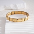Bracciale modulare in acciaio inossidabile dorato con segni di pace incisi su supporto - Tutto Oro