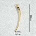 Macro shot of a 58mm gold tusk pendant with black pave stones for DIY jewelry making - Horn Style (DZM-3689)
