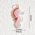 Macro view of gold-plated seahorse pendant with pink and orange enamel and size measurements - Colorful Seahorse Style (DYS-5465)