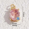 Macro detail of oval pink gemstone pendant with gold claw setting and blue zircon accent - Pink Oval Gem Style (DLD-5367)
