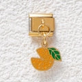 Macro shot of gold Italian charm link featuring a detailed orange slice with green leaf - Orange Style (GMKDZ-504)