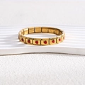 Detail of 18K gold stainless steel bracelet showing red strawberry enamel and material engraving - Full Bracelet / Gold Strawberry Style