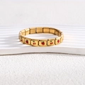 Detailed macro view of 18K gold modular charm bracelet with cherry and strawberry icons - Full Bracelet / Gold Mixed Symbols Style