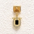 Macro detail of gold-plated shield charm with black stone and pave crystals on modular link - Black Shield Stone Style (MKDZ-850)