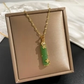 Detailed close-up of green bamboo pendant with gold butterfly and zircon inlay - Green Style (85069)