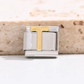 Macro view of modular Italian charm bracelet link with gold-tone letter T in stainless steel - Letter T