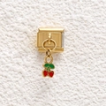 Macro detail of Italian golden modular charm link with a red and green cherry pendant - Cherry Style (GMKDZ-687)