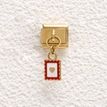 Detail of golden Italian charm with red scalloped edge and raised gold heart on white base - Stamp Heart Style (GMKDZ-694)