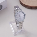 Detail showing the polished silver-tone metal strap and quartz watch face for women - Silver Simple Brushed Round Dial Style (WT047)