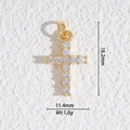 Détail macro d'un pendentif croix dorée avec zircons sur une surface en pierre blanche - Croix Pavée de Strass (DZ-3231)