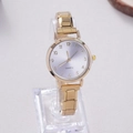 Detail of small gold quartz watch with a light purple radial dial on a clear display stand - Gold Purple Sunray Dial (WT056)