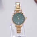 Close-up of golden women watch with green shimmering dial and rhinestone marker - Gold Green Frosted Dial (WT058)