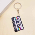 Retro 1980s music cassette tape acrylic keychain featuring colorful rainbow stripes - Black Background Rainbow Cassette Style (L)