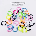 Macro detail of multi-colored spike horseshoe rings in 1.2x8x3mm for body piercing - Spike Solid Color Horseshoe Ring / 10 Pieces Pack