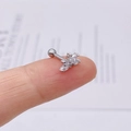 Primo piano di un orecchino a fiore in argento con zirconi incastonati sulle dita - Cluster di Fiori (JE0229A)