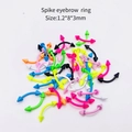 Macro shot of colorful 1.2x8x3mm spike eyebrow rings in various fluorescent finishes - Curved Spike Eyebrow Ring (JE0099D) / 10 Pieces Pack / Multicolor