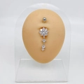Silver flower belly ring with clear cubic zirconia dangles on silicone body model - Eight Petal Flower Dangle Style (JE0172C)