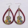 Detailed view of hollow wooden guitar earrings with bohemian paisley art patterns - Boho Guitar Style (JE0800F)