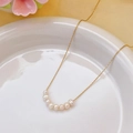 Minimalist freshwater pearl necklace with eight pearls on a gold chain in a white ceramic dish - 8 Small Freshwater Pearls