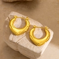 Textured gold U-shaped hoop earrings with hammered finish on neutral stone background - EH123/Irregular Lava Texture