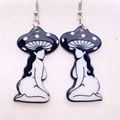 Macro detail of acrylic mushroom girl earrings with surreal black and white artistic charms - B&W Kneeling Mushroom Figure (JE0921B)