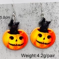 Detail of Halloween acrylic earrings featuring a black cat and pumpkin with size labels - Black Cat in Pumpkin (JE1054A)