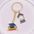 2024 Graduation souvenir keychain with graduation cap, diploma, and student charms - Cartoon Gown Student Book Certificate Style (JE1308F)
