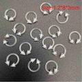 Macro shot of 1.2x8x3mm clear acrylic horseshoe body jewelry with triangular cone ends - Spike Nose Ring / 1 Piece