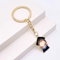 Graduation gift keychain featuring a golden ring and a cartoon doctor hat charm - Graduate Girl Enamel Style (JE1364E)