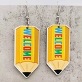 Close-up of yellow pencil drop earrings with Welcome text on marble background - Yellow Pencil Style (JE1361A)