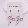 Silver drop earrings featuring pink iridescent bows with zircon centers on display card - Pink Purple Iridescent Bow Long Drop Earrings(JE1408B)