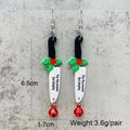 Detail of acrylic knife earrings with Tis the season for slaying text and size info - Festive Cleaver Style (JE1492F)