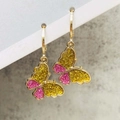 Close-up of golden hoop earrings featuring colorful glitter butterfly charms - Yellow and Pink Glitter Butterfly Style (JE1549H)