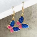 Macro view of butterfly earrings with dark blue and pink glitter in gold huggie hoops - Blue and Pink Sequin Butterfly Style (JE1549F)