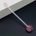 Macro detail of flexible acrylic belly bar with sparkling pink glitter ball ends - Transparent Pink Glitter Style (JE1587H)