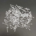 Macro shot of clear acrylic nose studs and ear retainers on black textured surface - 1 Piece / Round Top Straight Bar
