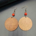 Detail of vintage round wooden earrings with red beads and bronze hooks on dark background - Round With Red Bead Style (JE1552F)