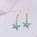 Detailed view of ocean style starfish earrings with blue enamel and gold finish - Sky Blue Enamel Starfish (JE1614U)