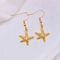Detailed macro view of golden starfish earrings with vibrant orange enamel coating - Orange Glazed Starfish (JE1614T)