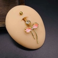 Gold-plated navel ring with pink bow pendant and shimmering tassels on model - Gold Pink Bow Tassel Style (JE1333B)