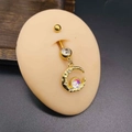 Detailed view of a golden moon navel ring with opal stone and crystals on skin model - Gold Colorful Opal Moon Style (JJE1333D)