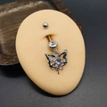 Macro shot of silver butterfly belly button ring with heart blue zircon on silicone model - Silver Blue Heart Butterfly Style (JE1615F)
