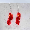 Detalle de los pendientes espirales de acrílico rojo con estrellas amarillas y diseño patrio - Estilo Bandera Espiral-China