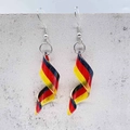 Macro detail of spiral acrylic earrings featuring German flag black red yellow stripes - Spiral Flag Style-Germany