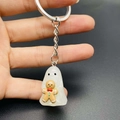Detail showing a translucent resin ghost holding a gingerbread man on a silver keychain - Ghost With Gingerbread Man Style (JE1521B)