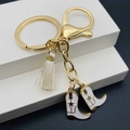 Detailansicht goldener Western-Cowboy-Schlüsselanhänger mit weißen Quasten und Stiefeln - Weißer Stiefelstil (A)