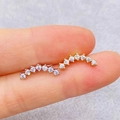 Golden and silver curved ear crawler set with seven sparkling round cubic zirconia - Curved Row Shape (JE1652R)