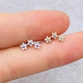 Golden flower cluster stud earrings with sparkling cubic zirconia on a minimalist base - Triple Flower Cluster (JE1652S)