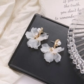 Elegant white petal drop earrings with gold accents and pearls on a premium black display - White Pearl Flower Stud Earrings (HZS596-7)