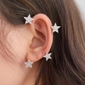 Close-up of model wearing sparkling silver star earrings with crystal inlay on earlobe - Left Ear / Silver Star (27#)